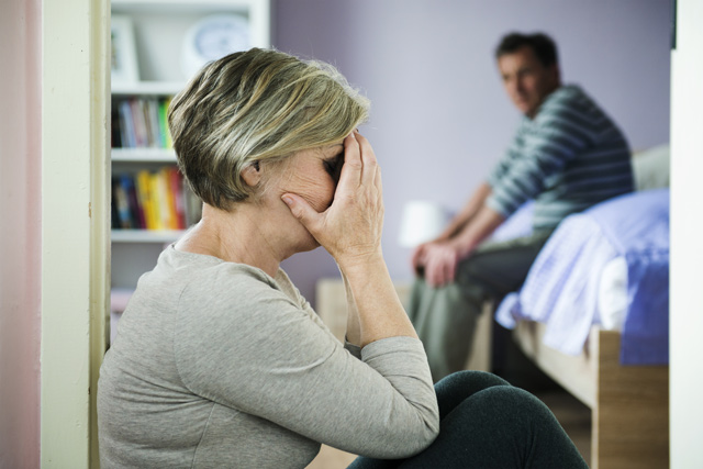 Mature woman with black eye is victim of domestic violence and abuse.
