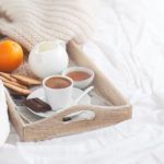 breakfast tray with coffee and an orange