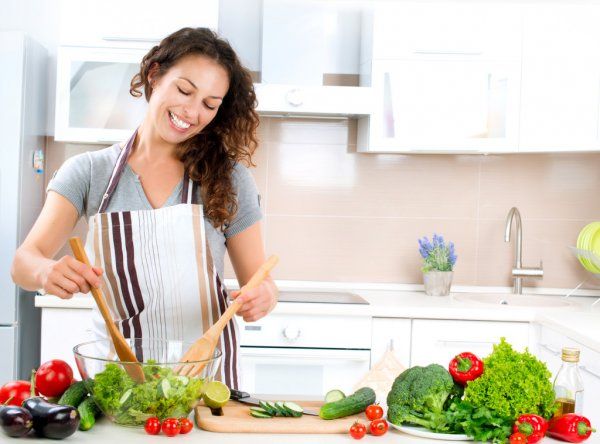 depositphotos 20382663 stock photo young woman cooking healthy food