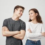 lovely couple looking at each other with crossed hands while smiling