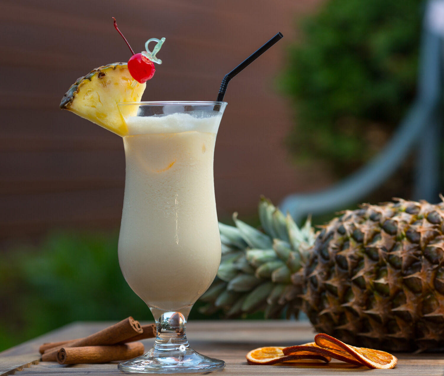 milky cocktail glass with pinapple slice cherry